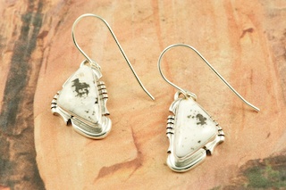 White Buffalo Turquoise set in Sterling Silver French Wire Earrings. This Beautiful Stone is formed from the minerals Calcite and Iron. It is mined near Tonopah Nevada. Created by Navajo Artist Arkie Nelson. Signed by the artist.